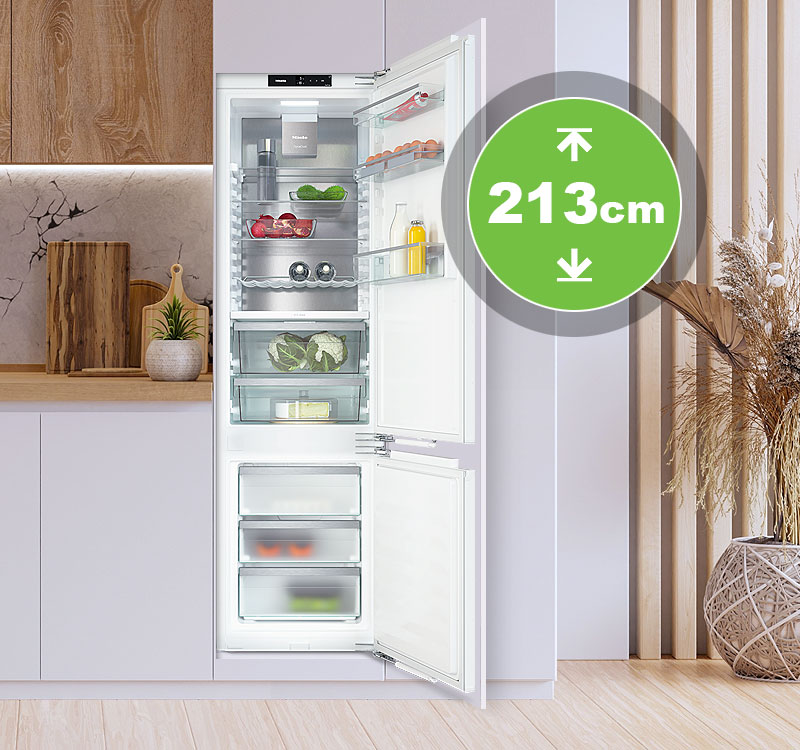 Inbouwkoelkast van 213 cm hoogte in maatwerkkeuken met open deur en ruime koel- en vriesindeling.