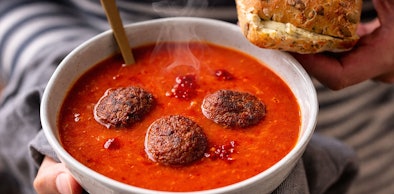 Dampende tomatensoep met gehaktballen opgewarmd in magnetron op 400 tot 600 watt zonder oververhitting