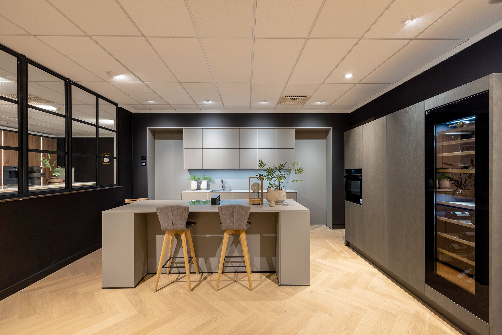 De ruime kastenwand is uitgevoerd met grafietgrijs geborsteld eiken.