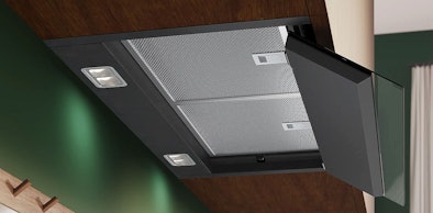 Geïntegreerde afzuigkap met ledverlichting op klep boven kookplaat in keuken