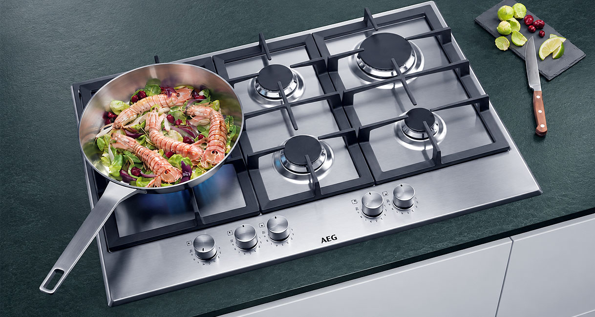 Pan met scampi op de brander van een AEG gaskookplaat met wokbrander