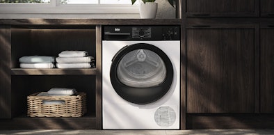 Beko warmtepompdroger in donkere houten kast met rieten wasmand voor betaalbare basisfuncties