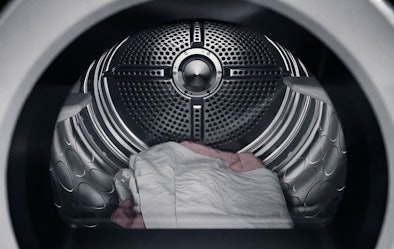 Close-up van ASKO wasdroger trommel met BundleGuard anti-klit systeem dat voorkomt dat wasgoed in elkaar draait