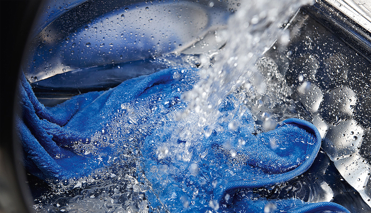 Water en wasmiddel worden via Spin&Spray technologie over één kledingstuk gesproeid