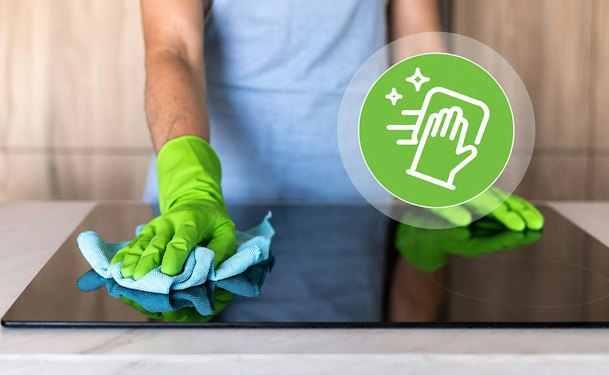 Inductie kookplaat schoonmaken met een vochtige microvezeldoek voor een streeploos resultaat