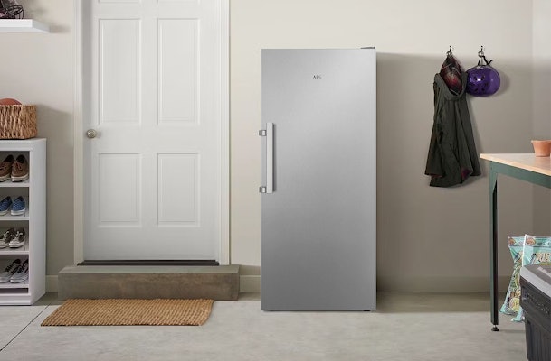 Vrijstaande AEG koelkast in een schuur naast een binnendeur, voorbeeld van koelkast voor in de schuur.