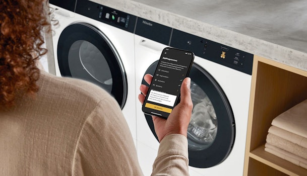 Miele@home app op smartphone bedient Miele W2 wasmachine op afstand AddProgrammes