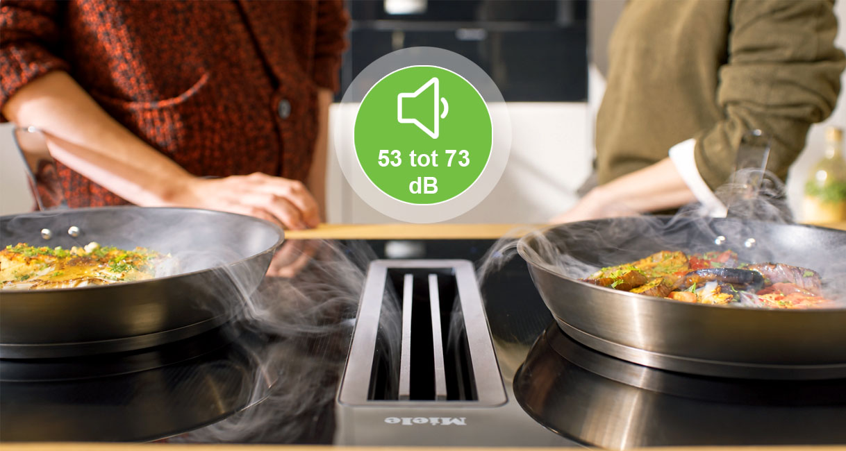 Twee wokpannen op kookplaat met afzuiging en aanduiding van 53 tot 73 dB