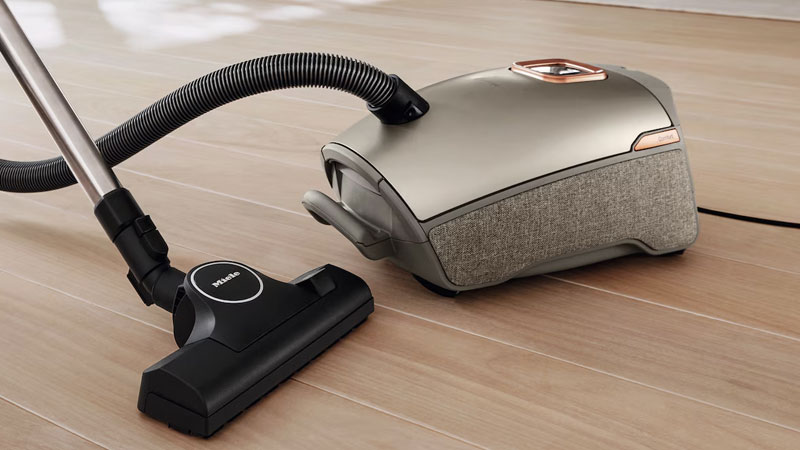 Miele stofzuiger met stofzak op houten vloer