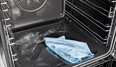 Miele oven pyrolyse zelfreiniging met as-resten na 440 graden reinigingscyclus, blauwe doek voor eenvoudig wegvegen