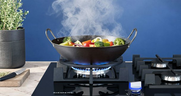 Siemens gaskookplaat met dampende wok op wokbrander