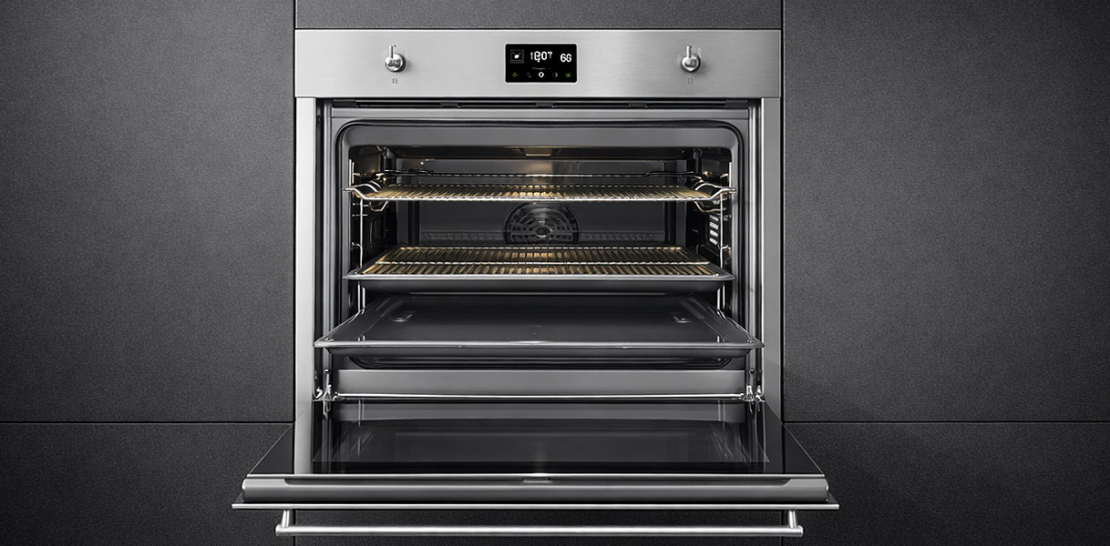 Smeg inbouw magnetron combi met open deur en roestvrij stalen binnenkant in donkere keukennis