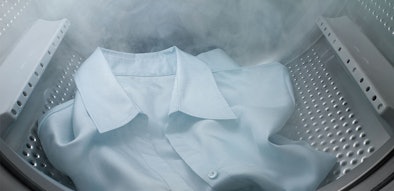 Overhemd wordt behandeld met stoom in wasmachine trommel