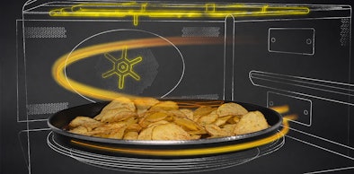 Aardappelschijfjes op een bakplaat in de magnetron met lichtlijnen die de hete lucht tonen